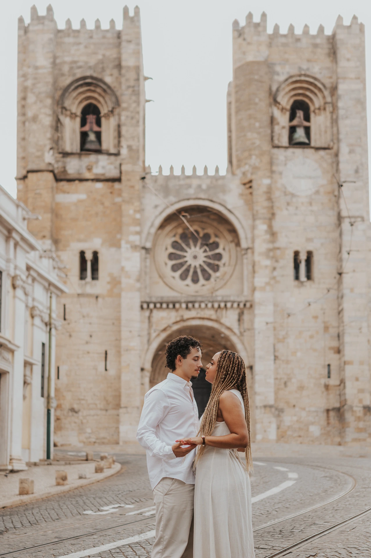 The couple together on the cobbled street in front of Lisbon’s cathedral during their couple photoshoot in Lisbon.