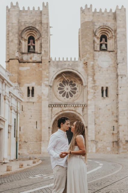 Together in front of the cathedral | Lisbon couple photoshoot The couple together on the cobbled street in front of Lisbon’s cathedral during their couple photoshoot in Lisbon.