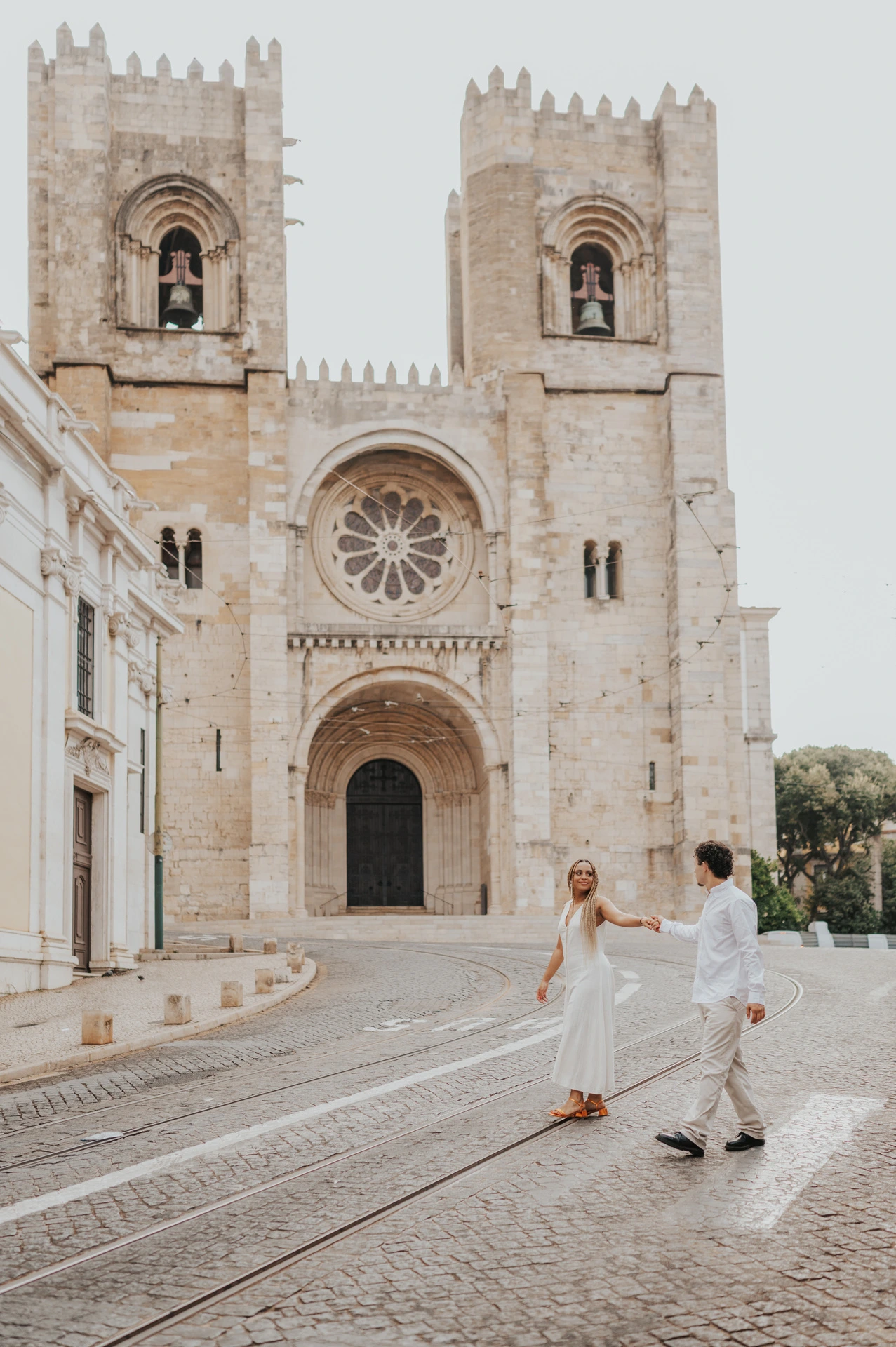 The couple together on the cobbled street in front of Lisbon’s cathedral during their couple photoshoot in Lisbon.