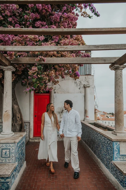 Hand in hand beneath the pergola | Lisbon couple photoshoot The couple holding hands beneath the garden pergola beside Portuguese tiles during their couple photoshoot in Lisbon.