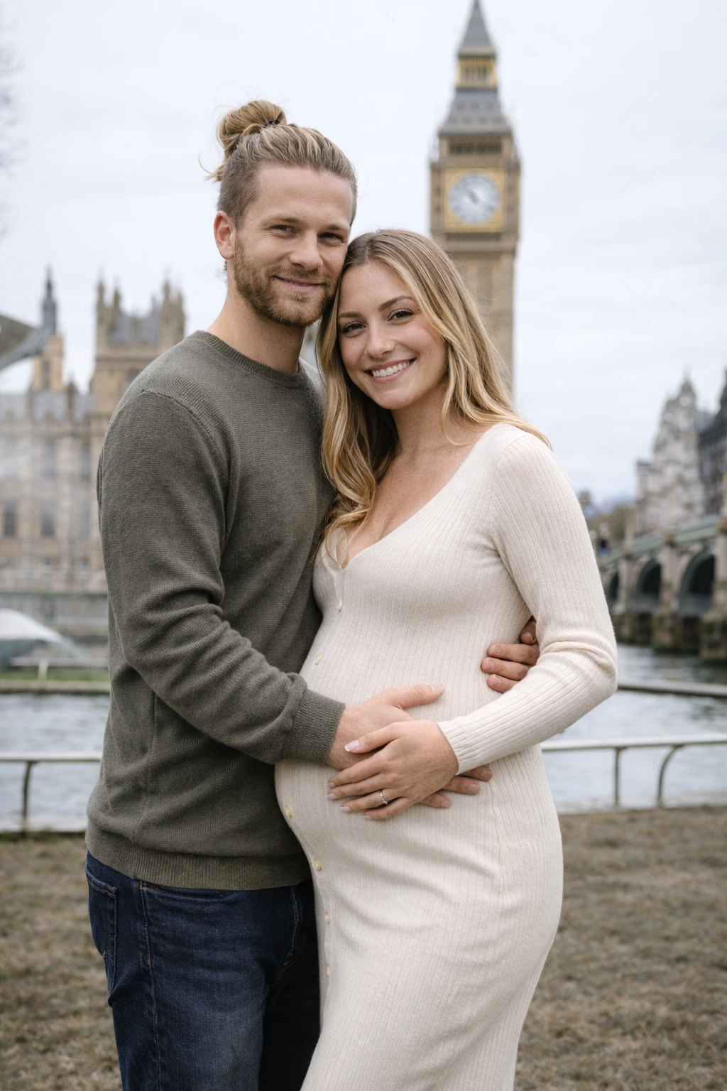 Close-up of couple’s hands on pregnant belly during maternity photoshoot on London riverside