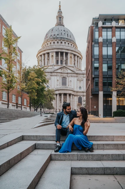 London proposal photoshoot: seated on the Peter’s Hill steps The couple seated together on the steps at Peter’s Hill with St Paul’s Cathedral at the end of the street during their London proposal photoshoot.
