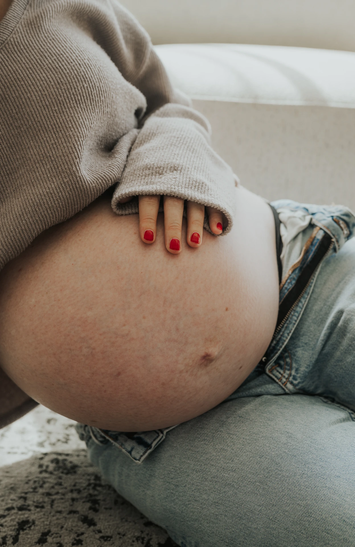 Close-up of pregnant belly during studio maternity photoshoot in Dubai