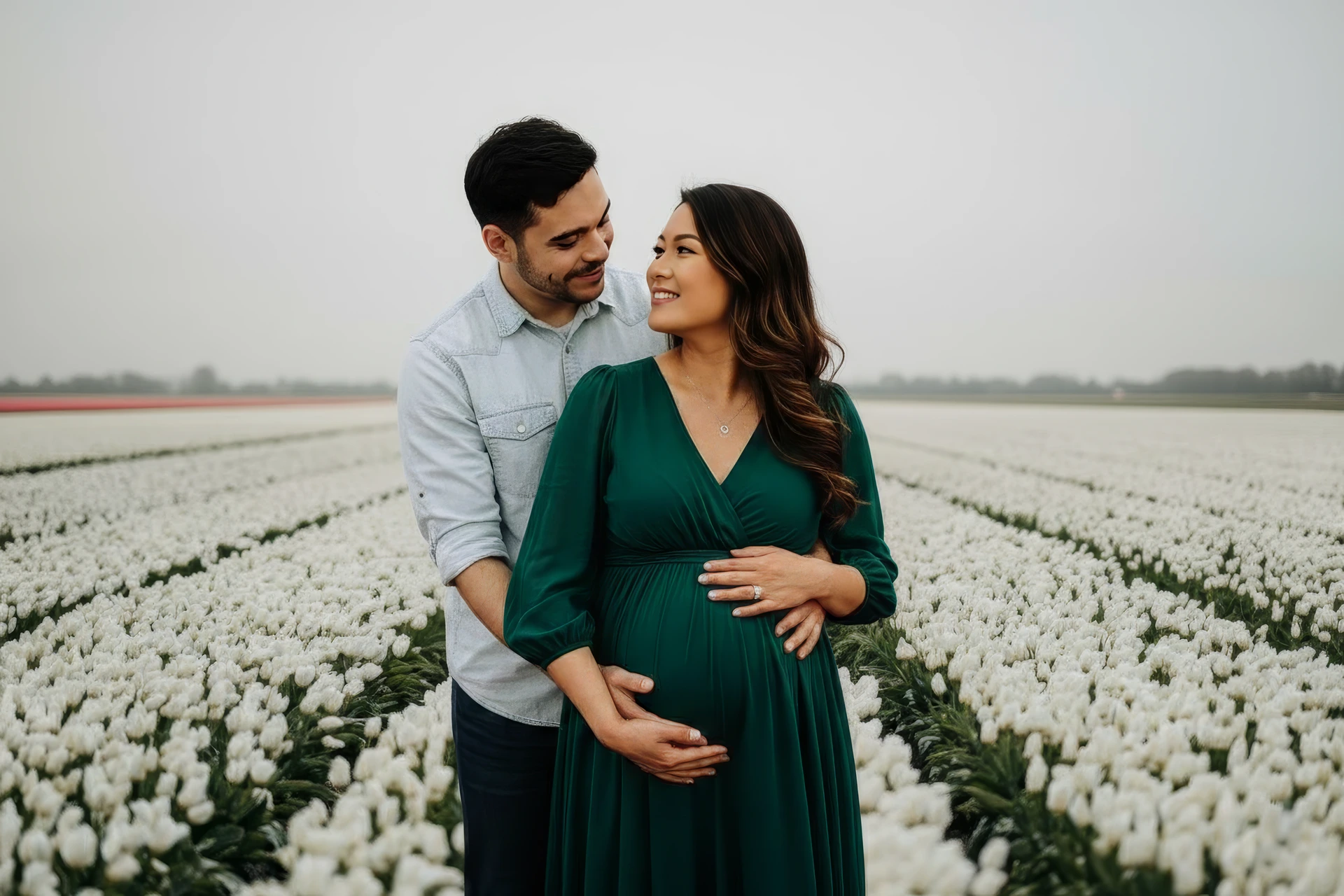 A couple doing a maternity photoshoot in the tulip fields in Amsterdam