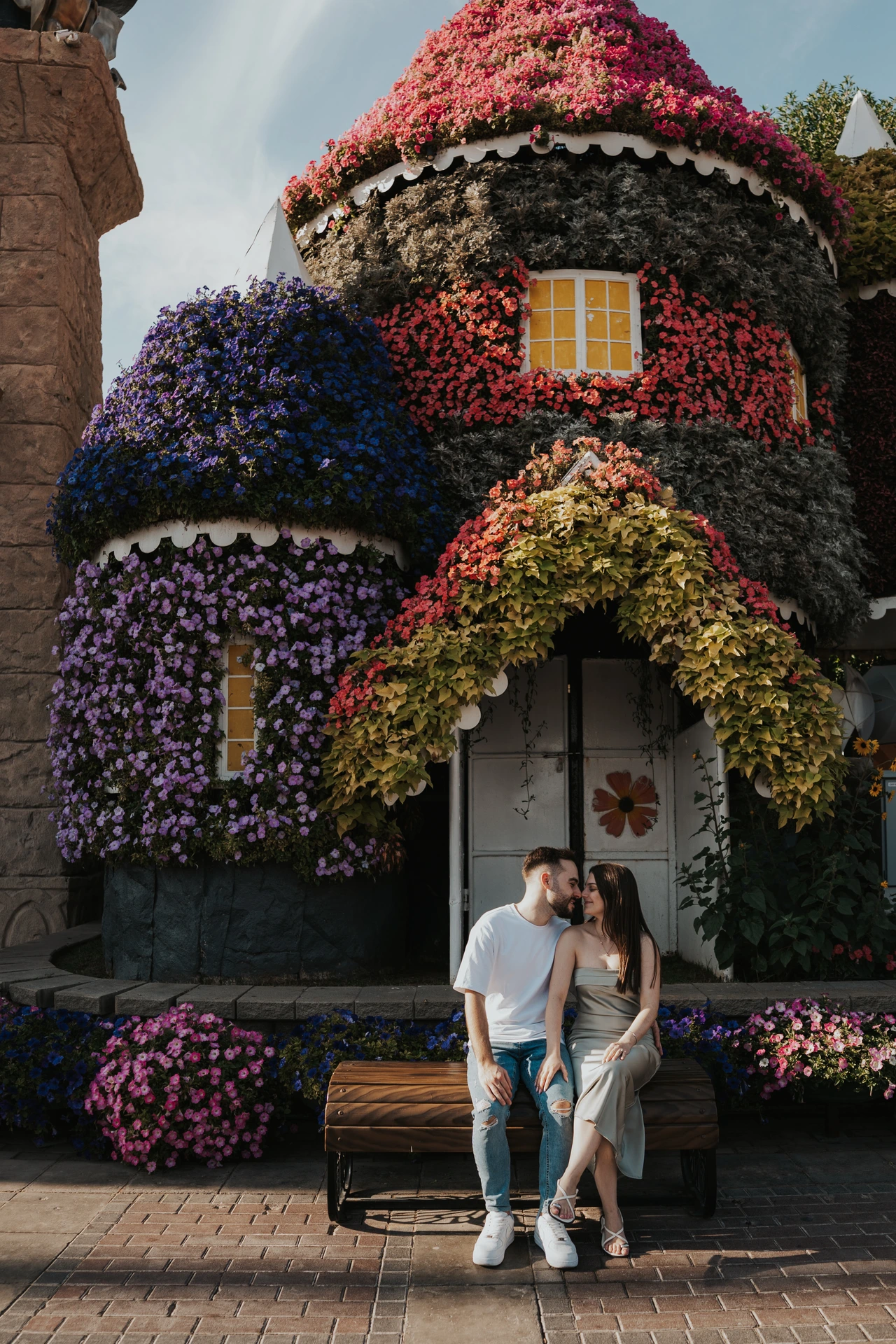 A surprise proposal photoshoot in Dubai Miracle Garden with bright floral scenery and an intimate couple moment.