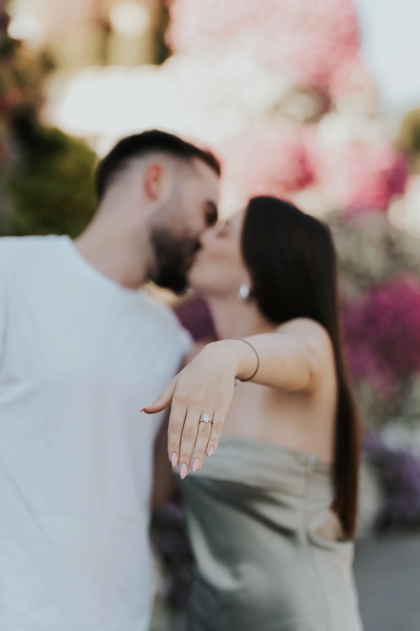 Miracle Garden proposal Dubai location A couple walking through Dubai Miracle Garden before their proposal photoshoot, surrounded by colorful floral installations.
