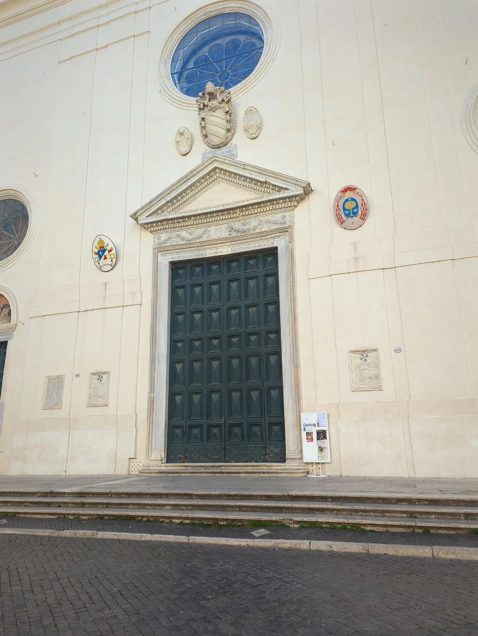 Pantheon and Piazza Navona Photoshoot - Monumental Doorway A monumental dark doorway sits beneath a circular window on a pale church facade near the Pantheon route in Rome.
