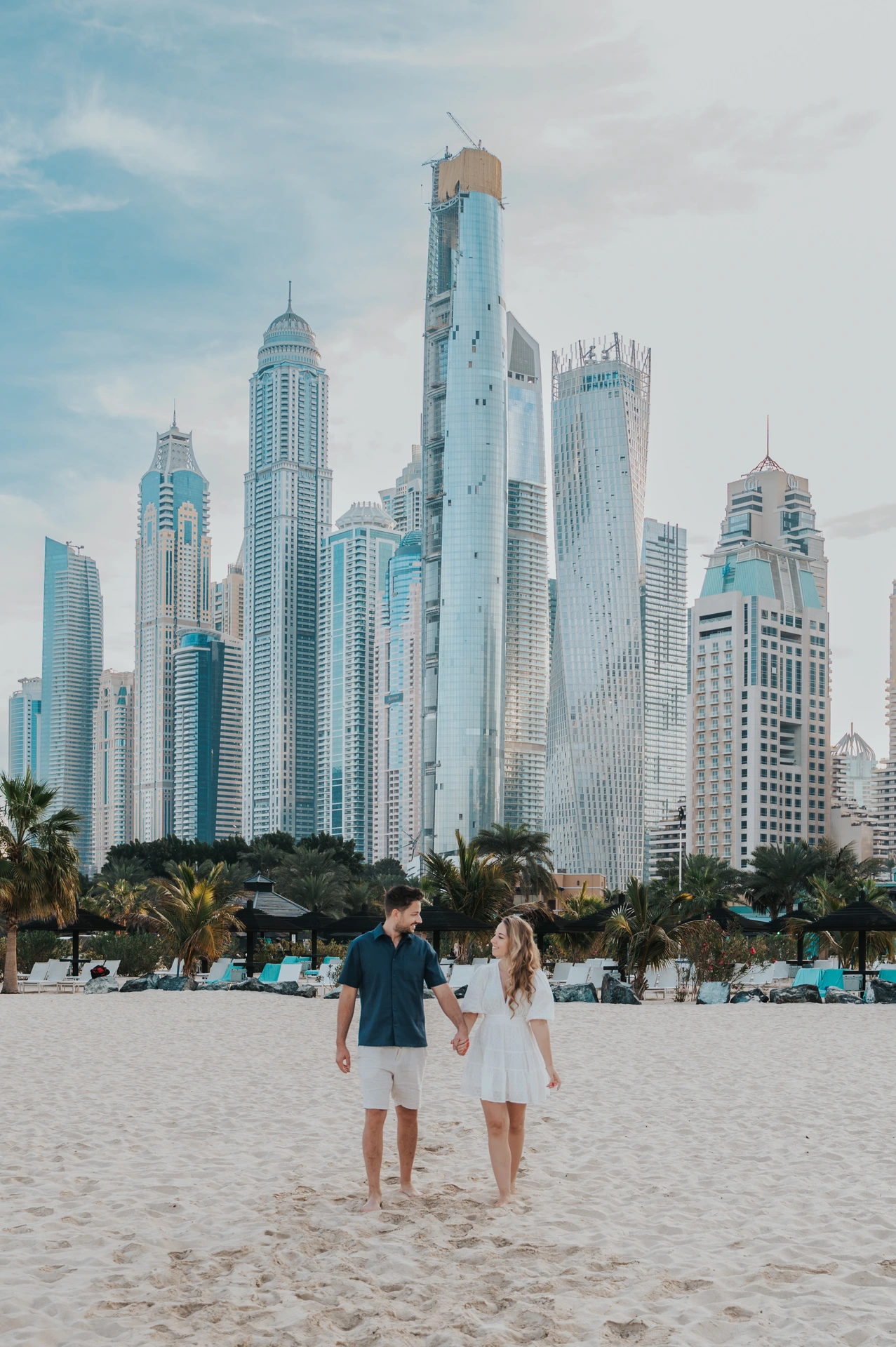 Couple at JBR beach with Dubai Marina skyline