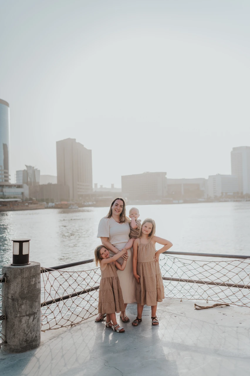 Mother with children by Dubai waterfront during Mother’s Day photoshoot Mother with children by Dubai waterfront during Mother’s Day photoshoot