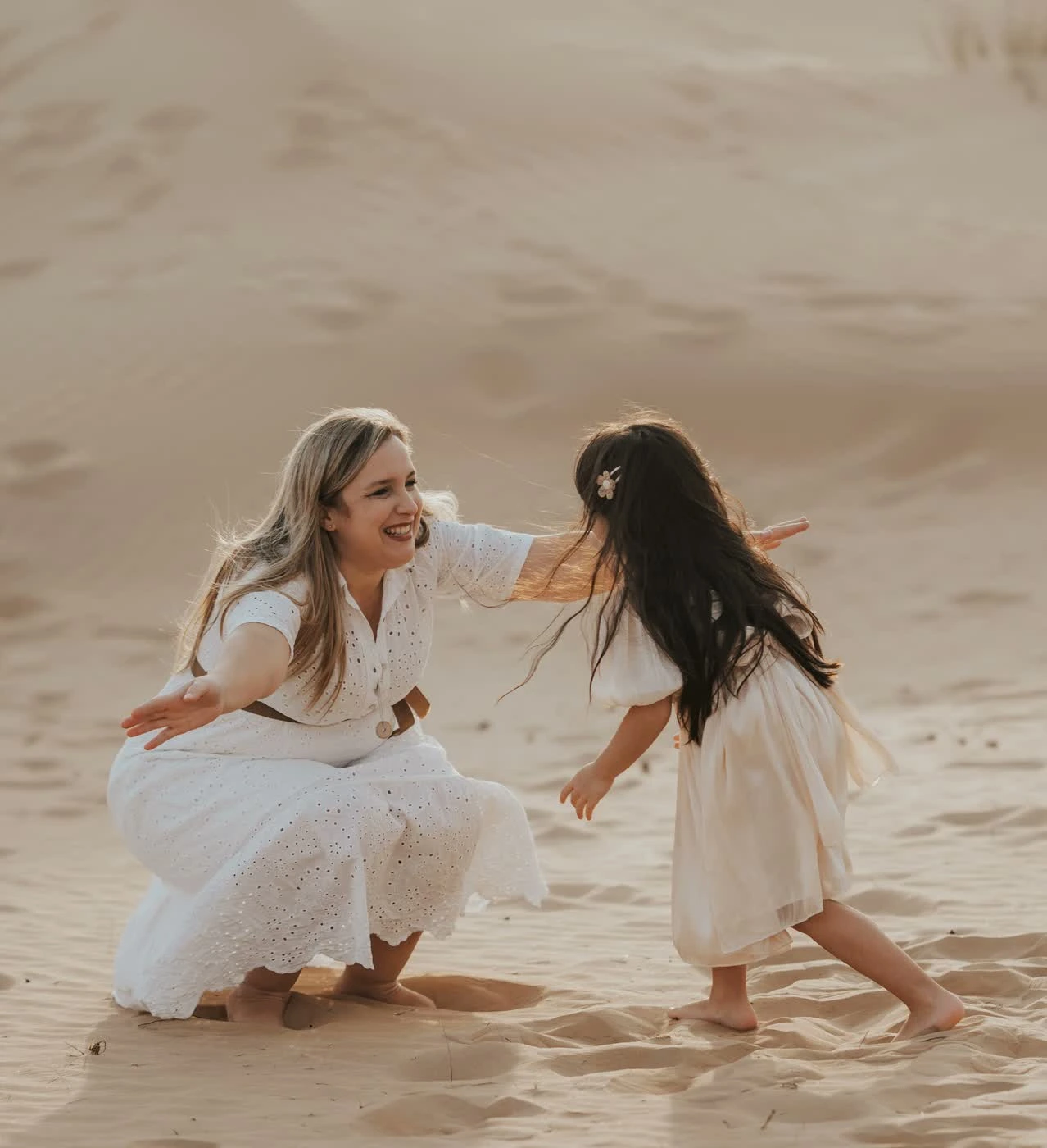 Mother and daughter smiling together while reading a gift card