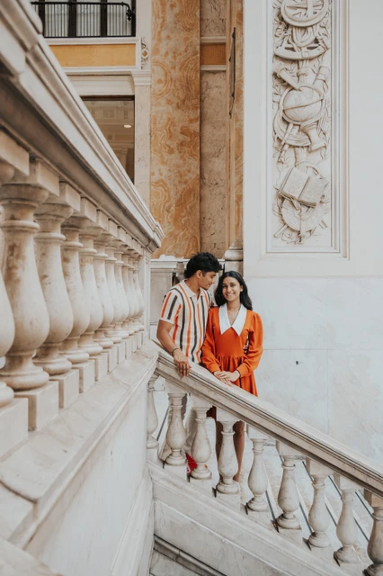 Couple on an ornate marble staircase in Naples