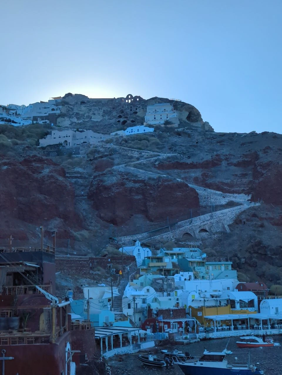 Oia to Ammoudi harbour path and boats | Santorini Stone steps winding down from Oia Castle to the boats and waterfront buildings of Ammoudi harbour