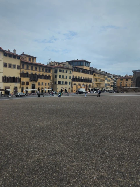 Oltrarno Piazza by Palazzo Pitti A broad paved piazza and rows of warm-coloured historic buildings form an architectural setting near Palazzo Pitti in Florence.