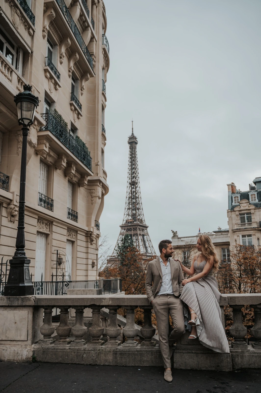 A couple photoshoot scene in Paris with natural movement, candid connection, and elegant city surroundings.
