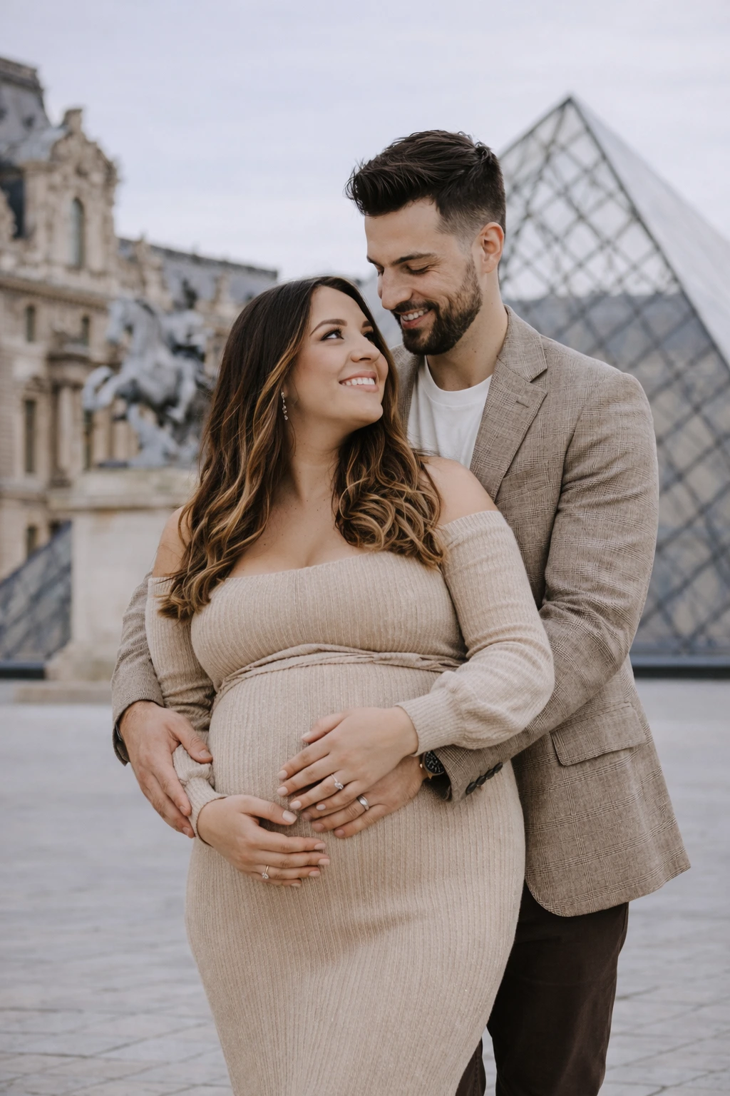 A maternity portrait beside the Louvre Pyramid in Paris.