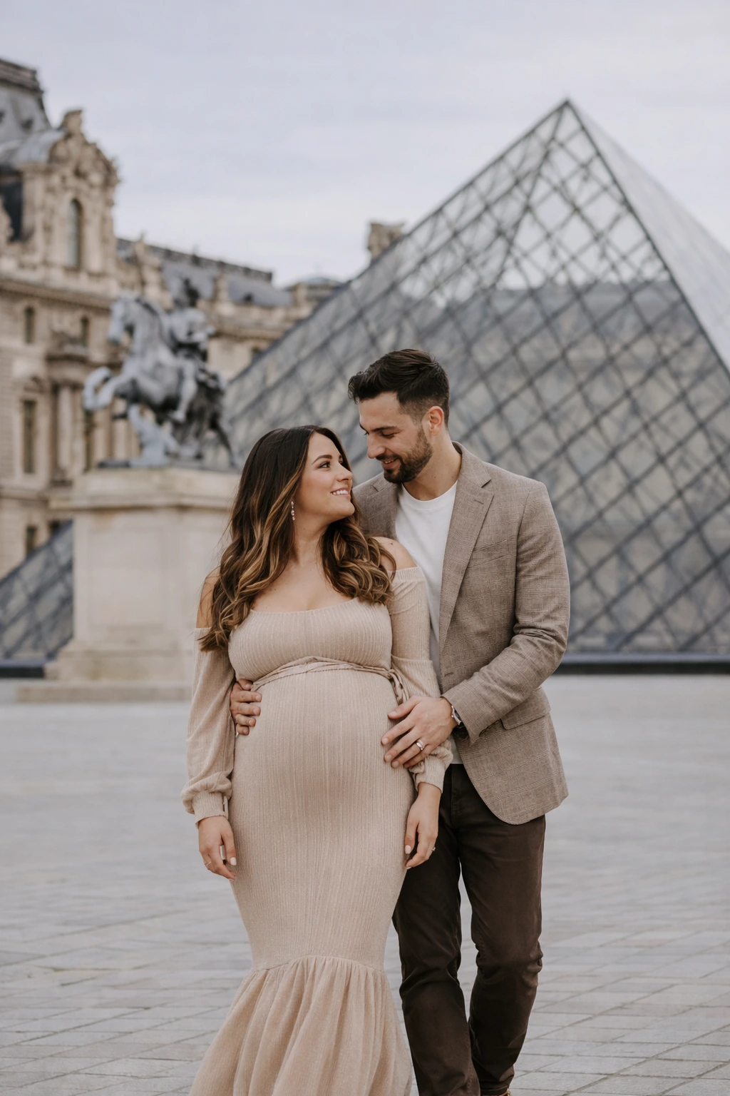 A maternity portrait beside the Louvre Pyramid in Paris.