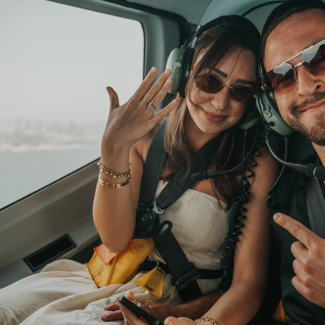 Dubai Proposal Photographer Couple being photographed during their proposal in a helicopter above Dubai