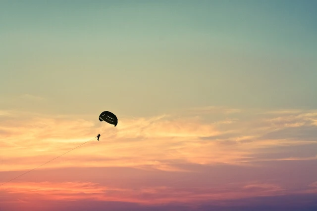Parasailer above the sea during a warm Phuket sunset