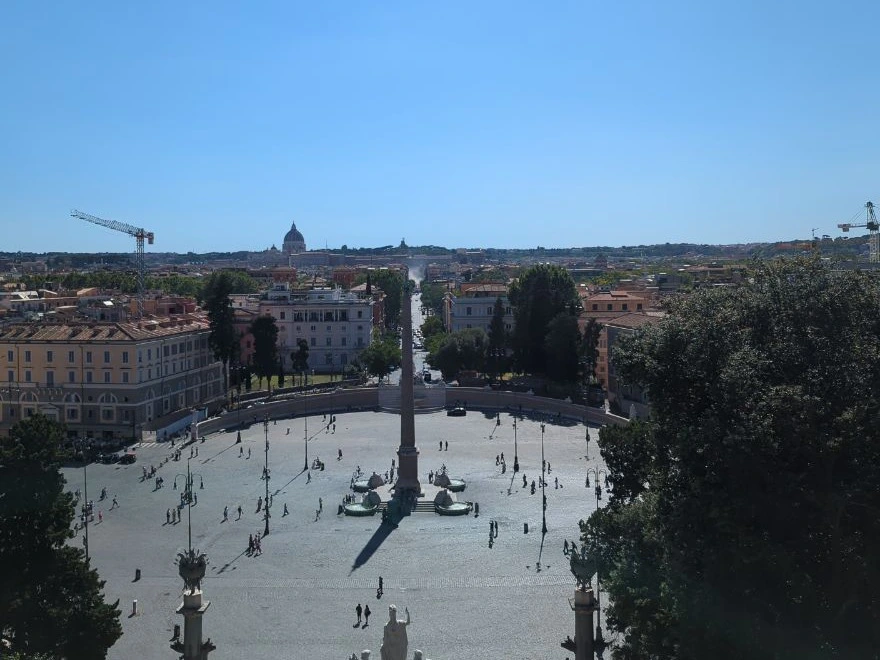 Piazza del Popolo, its central obelisk and Rome's rooftops spread below the elevated Pincio terrace as a broad photoshoot backdrop.