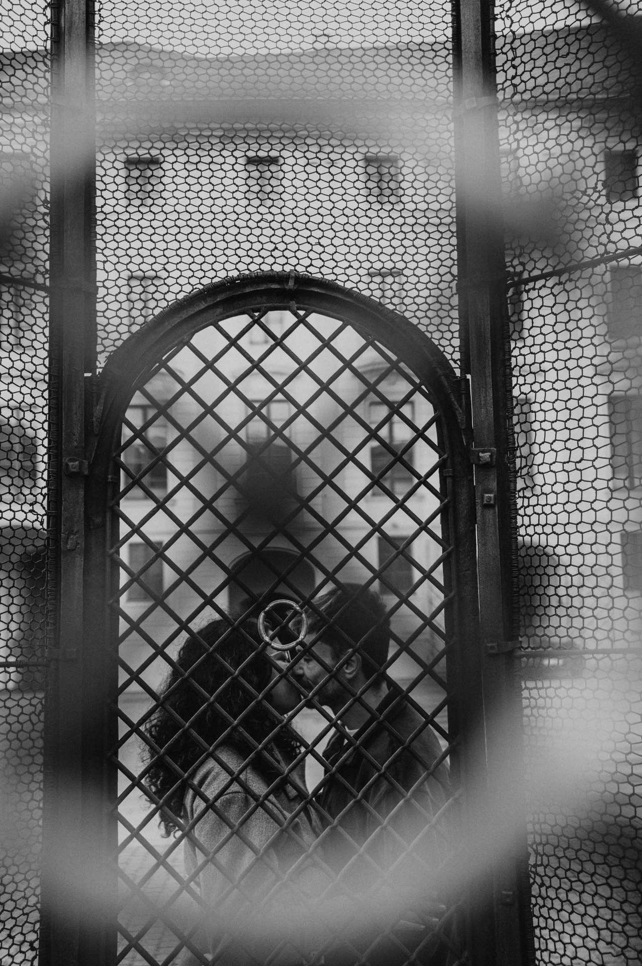 Black and white portrait through the decorative gate during an anniversary couple photoshoot in Prague.
