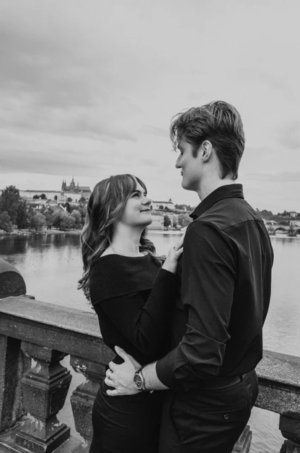 Prague couple photoshoot: black and white embrace on Legion Bridge. Black and white embrace on Legion Bridge during a couple photoshoot in Prague.