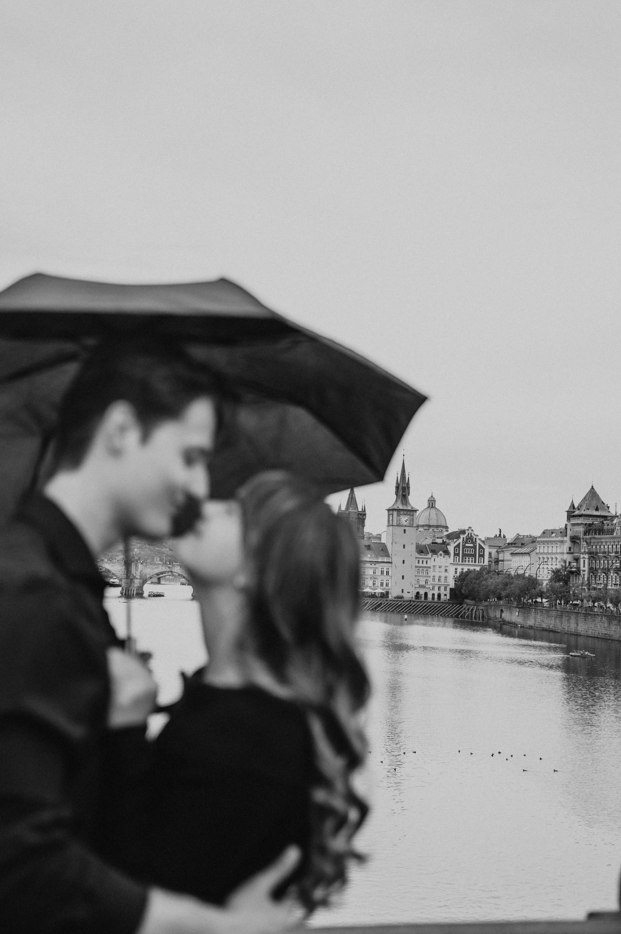 Black and white soft-focus umbrella portrait during a couple photoshoot in Prague.