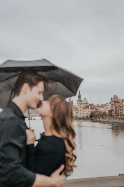 Prague couple photoshoot: soft-focus portrait of the couple beneath the umbrella. Soft-focus portrait of the couple beneath the umbrella during a couple photoshoot in Prague.