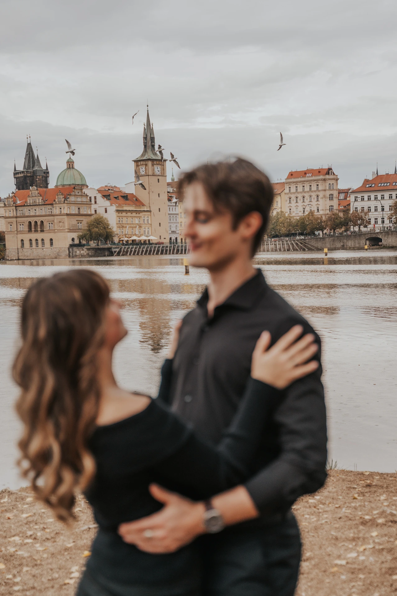 Soft-focus portrait of the couple embracing on the island during a couple photoshoot in Prague.