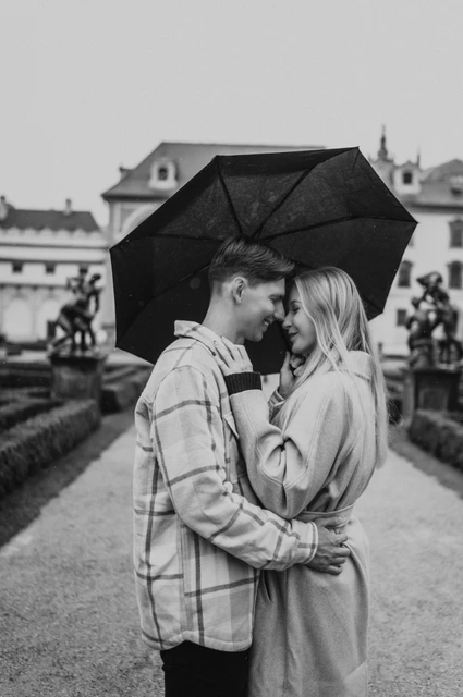 Prague couple photoshoot: a black-and-white umbrella portrait Black-and-white close portrait of the couple touching foreheads beneath an umbrella during their Prague couple photoshoot.