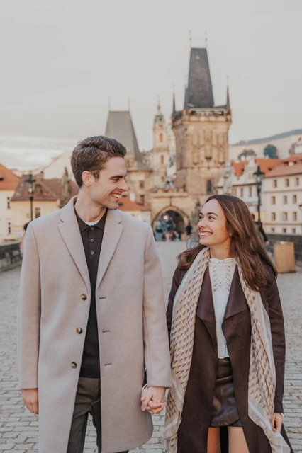 Holding hands on Charles Bridge Close portrait of the couple holding hands on Charles Bridge at their Prague engagement photoshoot