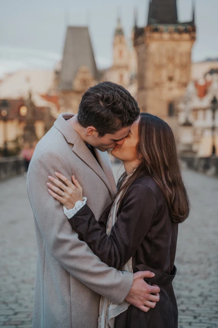 A kiss on Charles Bridge Couple sharing a kiss on Charles Bridge during their Prague engagement photoshoot