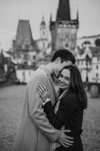 Charles Bridge embrace in black and white Black and white portrait of the couple embracing on Charles Bridge during their Prague engagement photoshoot