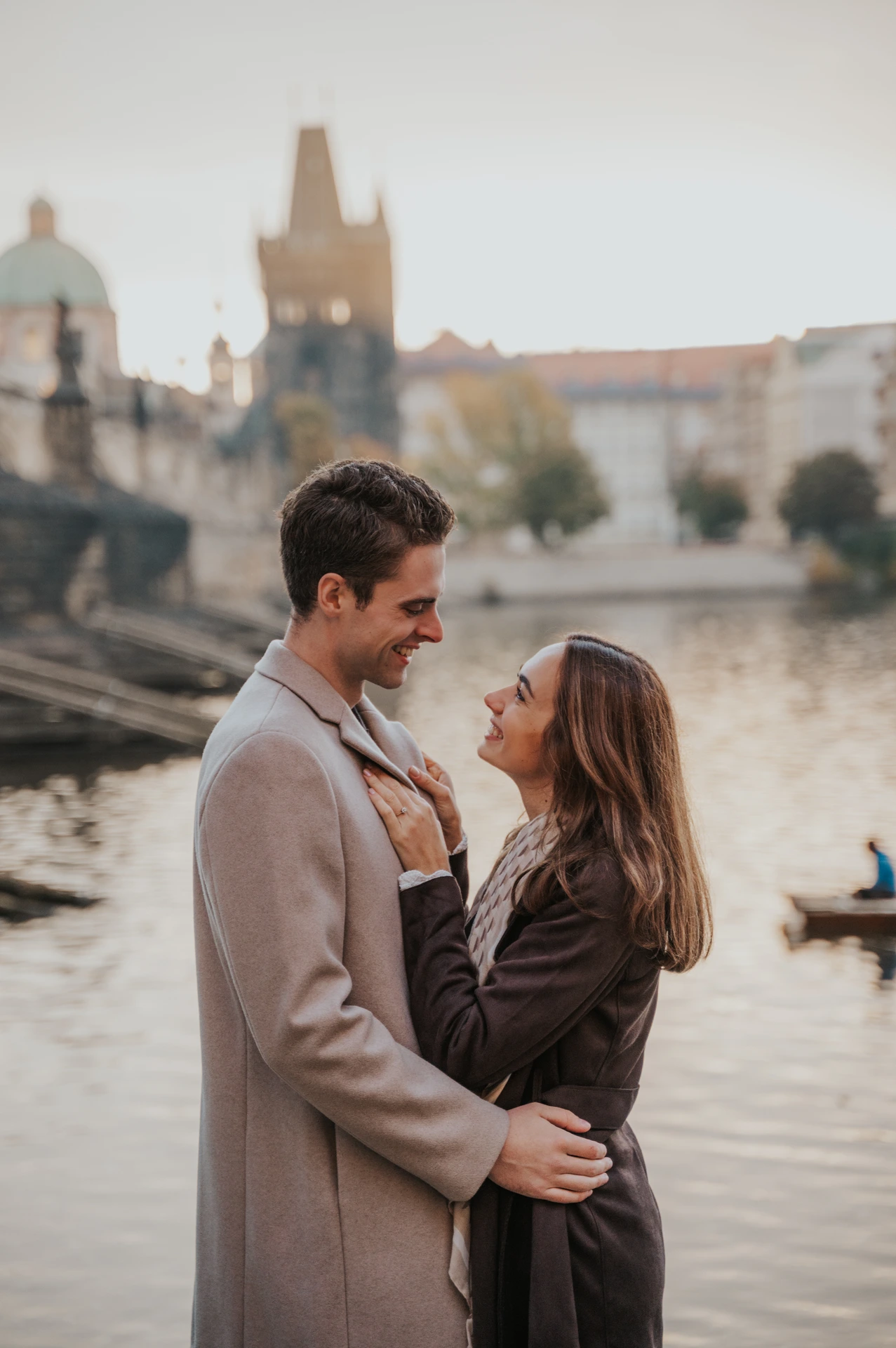 Couple looking at each other on the Kampa riverbank during their engagement photoshoot in Prague