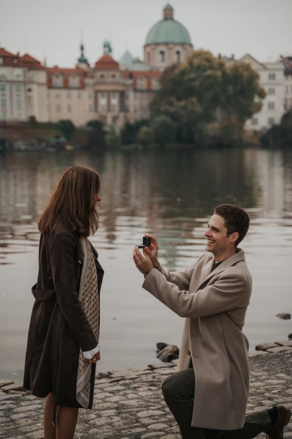A close view of the Prague proposal Close view of the man proposing to his partner beside the river during their Prague proposal photoshoot