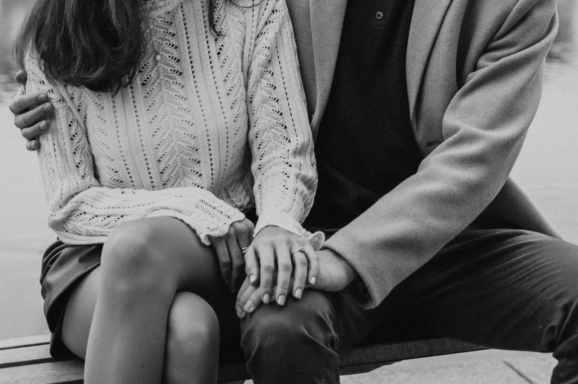 Black and white detail of the couple's hands and engagement ring after their proposal photoshoot in Prague