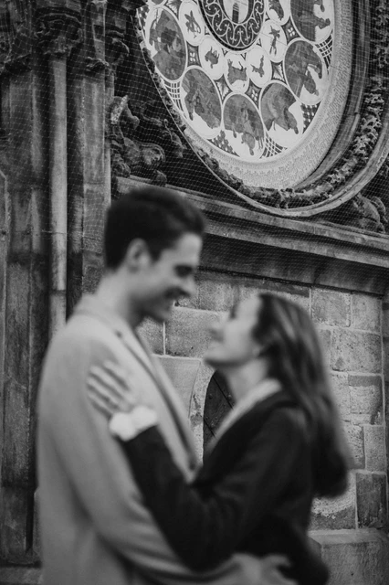 The Astronomical Clock in black and white Black and white close portrait beneath the Astronomical Clock during the couple's Prague engagement photoshoot