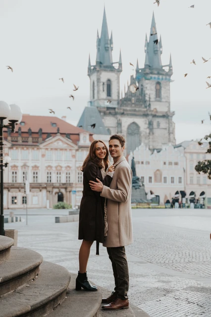 Smiles in Prague's Old Town Square Couple smiling towards the camera in Old Town Square during their engagement photoshoot in Prague