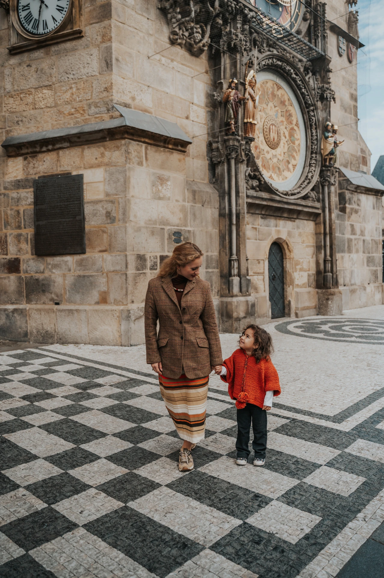 Mother holding her daughter’s hand in Old Town during a mother and daughter family photoshoot in Prague.