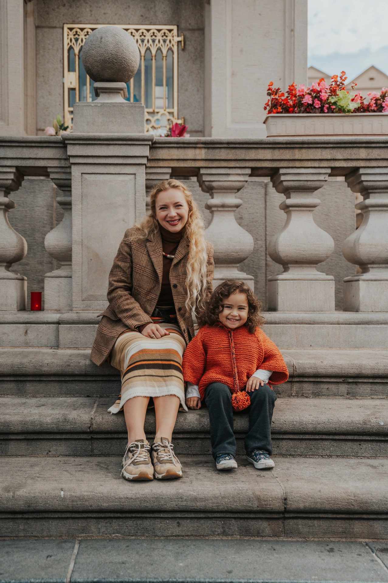 Wide portrait of mother and daughter on the Old Town steps during a mother and daughter family photoshoot in Prague.