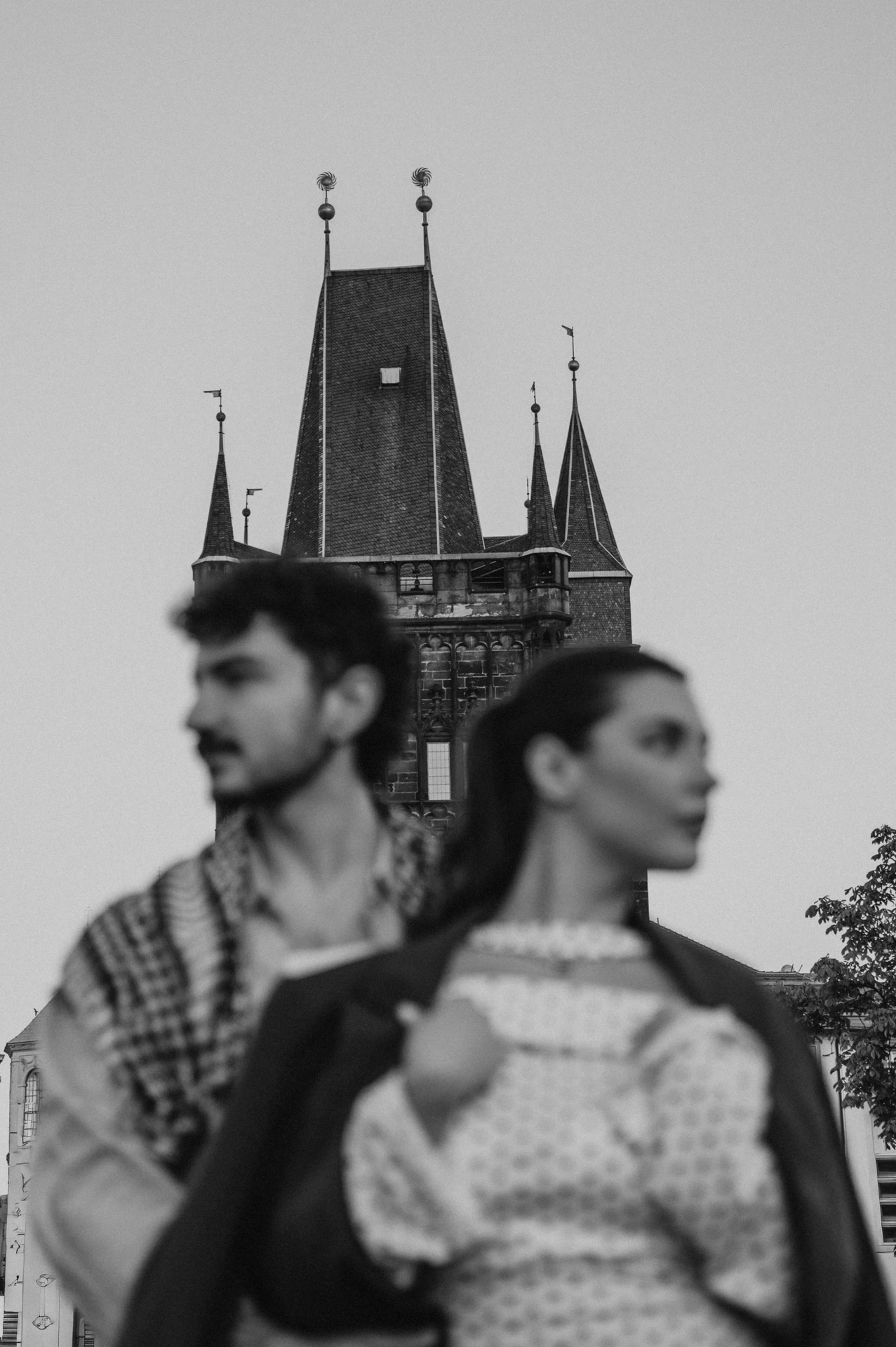 Black and white portrait with a checked wrap on the bridge during a couple photoshoot in Prague.