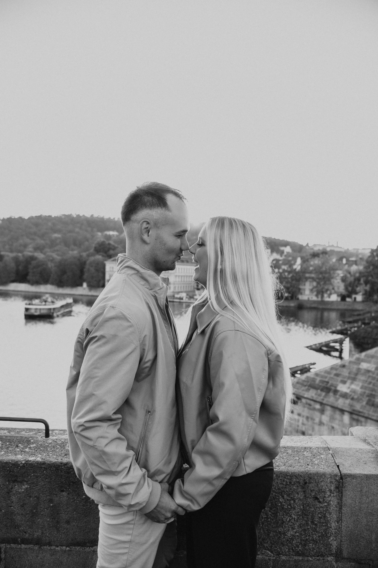 Black and white portrait of the couple beside the river during a couple photoshoot in Prague.