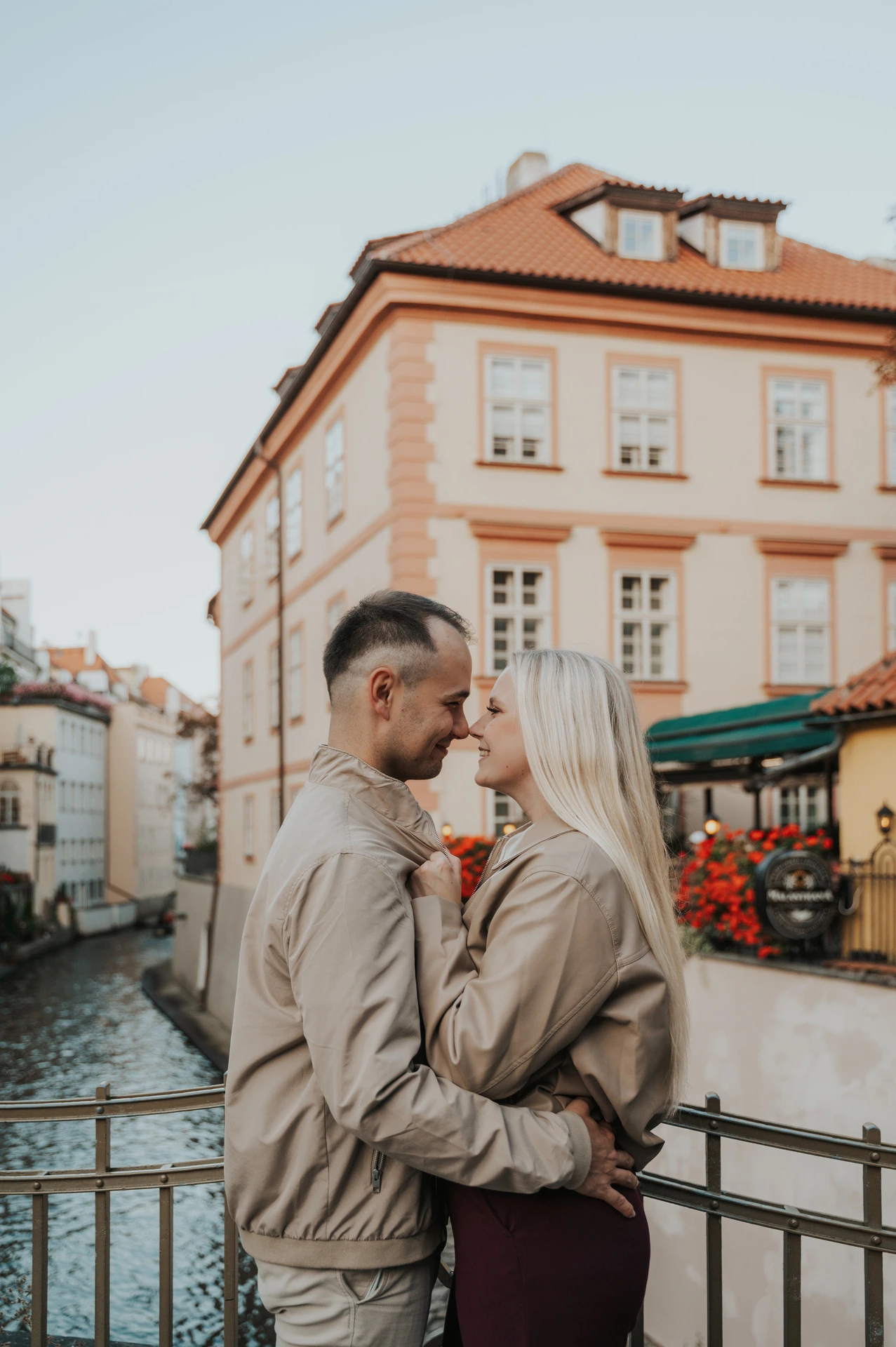 Couple embracing beside the canal in Kampa during a couple photoshoot in Prague.