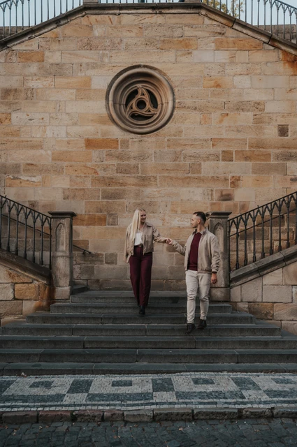 Prague couple photoshoot: couple walking down the Kampa stairs together. Couple walking down the Kampa stairs together during a couple photoshoot in Prague.