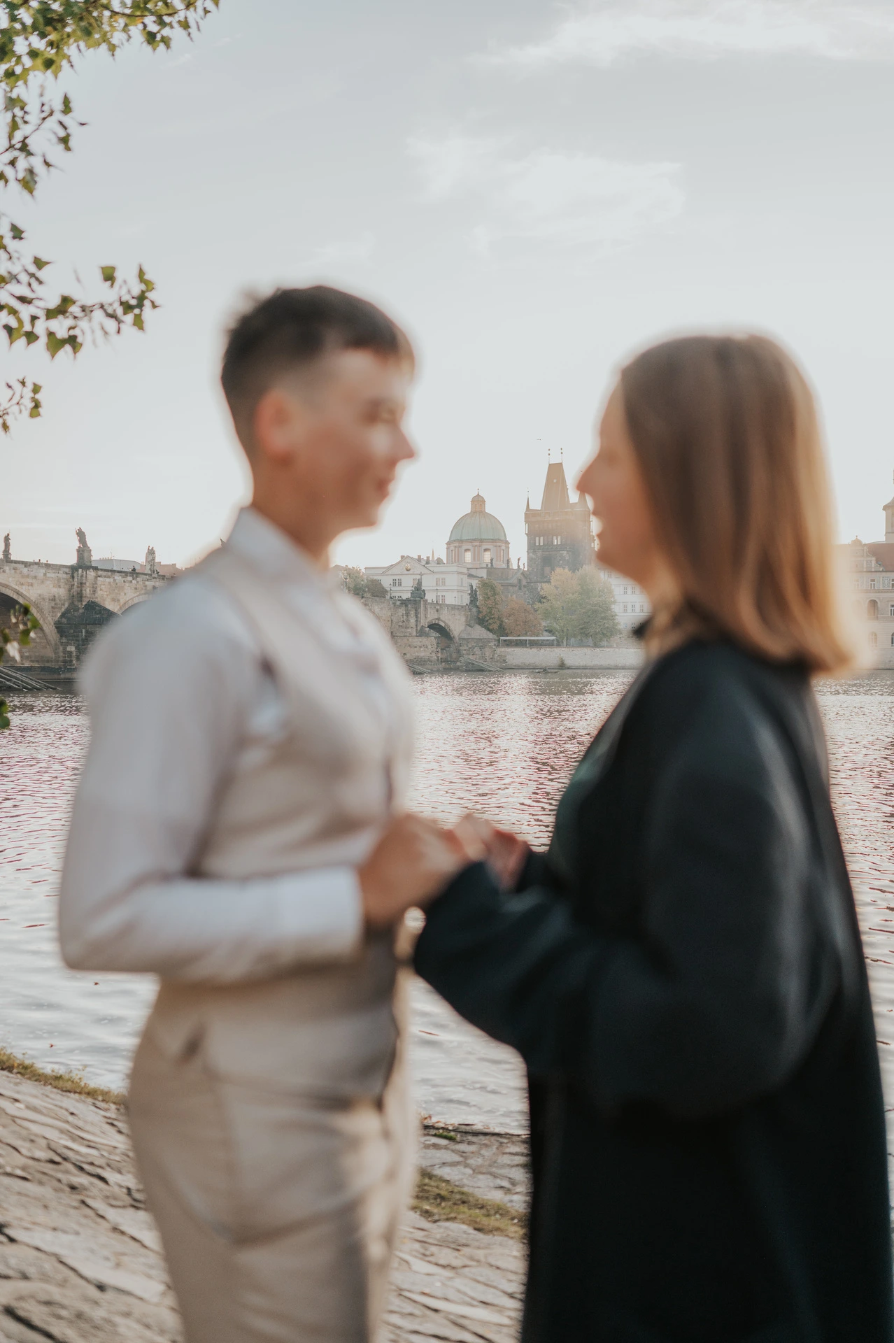 Close portrait of the couple beside the river during a couple photoshoot in Prague.