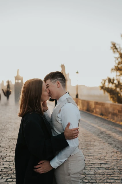 Close portrait of the couple kissing on Charles Bridge during a couple photoshoot in Prague.