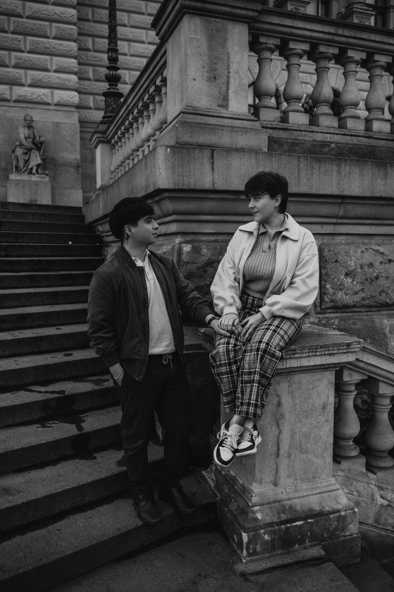 Black and white portrait at the museum balustrade during a couple photoshoot in Prague.