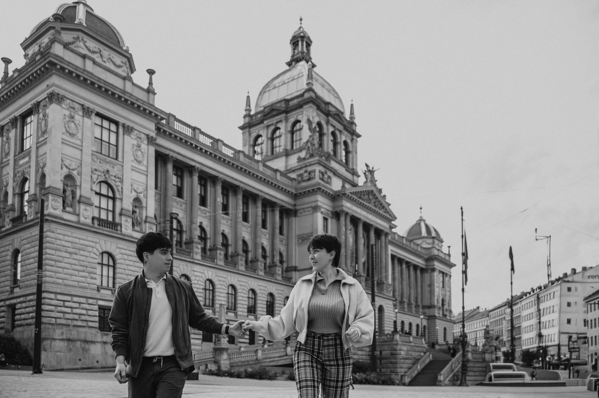 Black and white portrait with the National Museum behind them during a couple photoshoot in Prague.