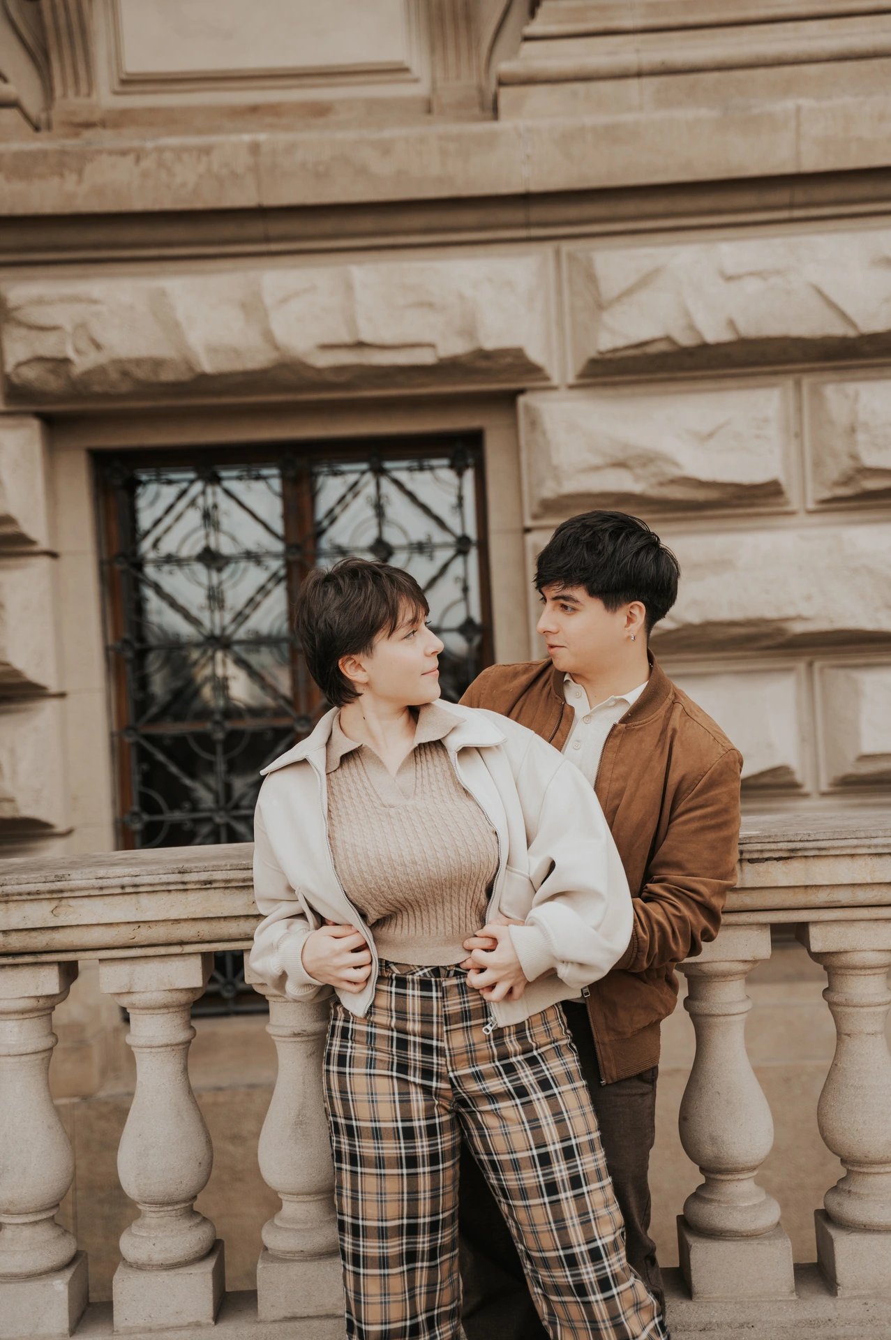 Couple embracing at the stone balustrade during a couple photoshoot in Prague.