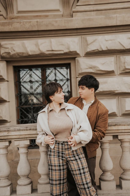 Prague couple photoshoot: couple embracing at the stone balustrade. Couple embracing at the stone balustrade during a couple photoshoot in Prague.