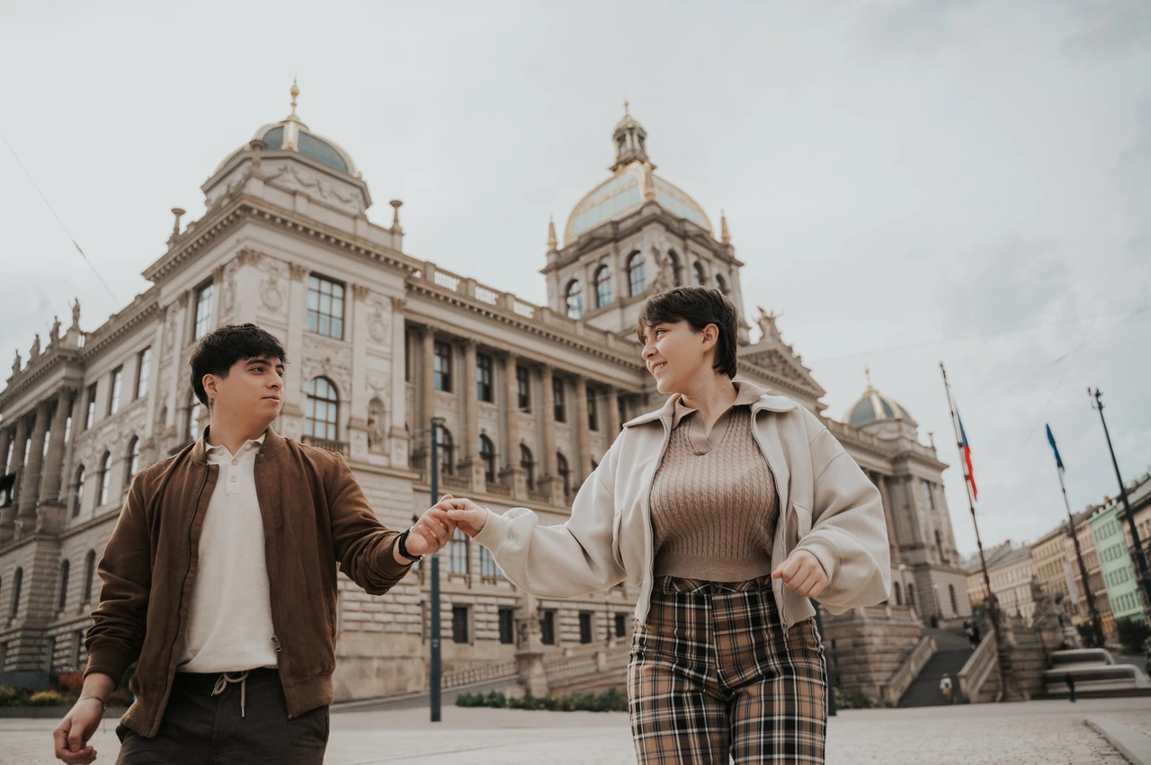 Prague couple photoshoot: couple smiling together in front of the National Museum. Couple smiling together in front of the National Museum during a couple photoshoot in Prague.